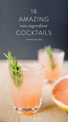 two glasses filled with grapefruit and garnish sitting on top of a wooden table