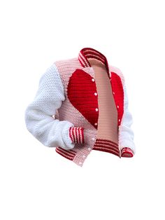 a red and white knitted sweater with a heart on the chest, in front of a white background