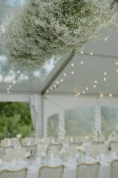 the tables are set with white linens and flowers