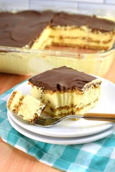 a piece of cake on a plate with a fork in front of it and another slice missing