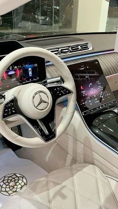 the interior of a car with steering wheel, dashboard and touchscreens on display