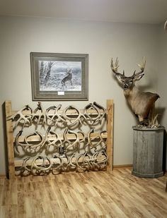 a deer head mounted to the side of a wall next to a wooden bed frame