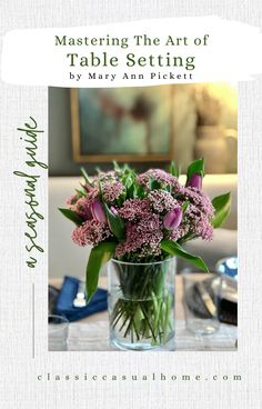 a vase filled with purple flowers on top of a table