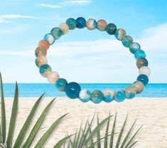 This simple, yet gorgeous stretch bracelet is made with natural jade, white, blue and peach round, smooth 6 mm beads. It is the perfect bracelet for the beach and for those warm summer days🏝☀️🏝☀️.  This is a stretch bracelet made with 100% polyester stretch cord (not wire). Please refer to the last picture when ordering your bracelet size. BEAD COLORS WILL VARY WITH EACH BRACELET!  The matching necklace (sold separately) is available in my Etsy shop. Vacation Stretch Bracelet With Round Beads, Beach Stretch Bracelet With Gemstone Beads, Stretch Bracelet With Gemstone Round Beads For Beach, Beach Stretch Bracelet With Round Gemstone Beads, Natural Stones Stretch Bracelet With Round Beads For Beach, Hand-strung Crystal Bracelet With Round Beads For Beach, Beach Bracelet, Bracelet Summer, Summer Bracelet