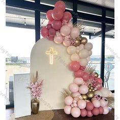 a church decorated with balloons, flowers and a crucifix in the background