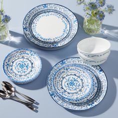 blue and white dinnerware with flowers in vases