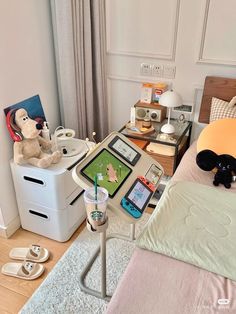 a bed room with a neatly made bed and a teddy bear on the side table