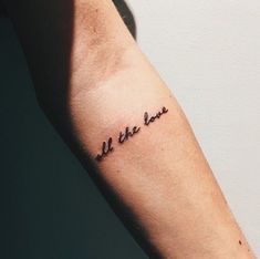 a person with a tattoo on their arm that says, be the love