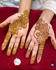 two hands with henna designs on them