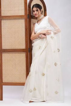 Off white pure silk organza saree with placement vintage motifs, contrast resham and sequin embroidery. Comes with unstitched blouse piece. - Aza Fashions White Chanderi Pre-draped Saree For Celebration, Semi-stitched White Organza Saree, Organza Blouse For Wedding And Eid Festival, Wedding Eid Organza Blouse, Wedding Blouse In Organza With Chikankari Embroidery, Wedding Blouse In Organza With Cutdana, White Tissue Silk Pre-draped Saree With Unstitched Blouse, Wedding Organza Blouse With Chikankari Embroidery, White Organza Pre-draped Saree For Eid