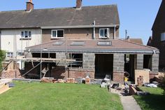 a house being built in the middle of a yard with scaffolding around it