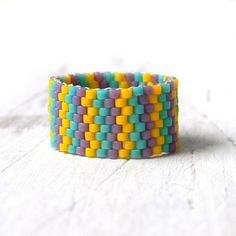 a multicolored woven bracelet sitting on top of a table