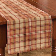 a plaid table runner on top of a wooden table