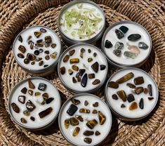 six small bowls filled with different types of rocks on top of a wicker basket