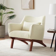 a white chair sitting on top of a rug next to a table