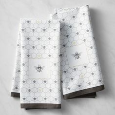 three bees and honeycombs printed napkins on a marble countertop with dark brown trim