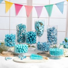 a table topped with lots of blue candies and other candy items on top of it