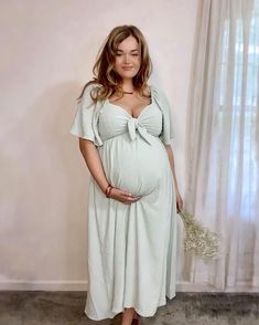 A textured dot maternity midi dress featuring a v-neckline with an adjustable front tie, a front cutout, short ruffle sleeves, a smocked elastic back, an empire waist and double lined. Maternity Midi Dress, Pink Blush Maternity, Ruffle Sleeves, Maternity Clothes, Empire Waist, White Formal Dress, Mint Green, Blush Pink, Midi Dress