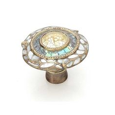 an antique brass and mother of pearl cabinet knob