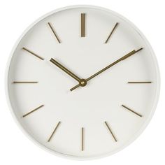 a white clock with gold hands on a white background