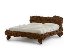 a bed made out of wood with white sheets