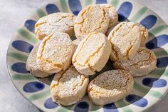 a plate full of sugar cookies sitting on a table top with blue and green stripes