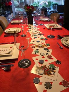 a long table with cards and wine glasses on it