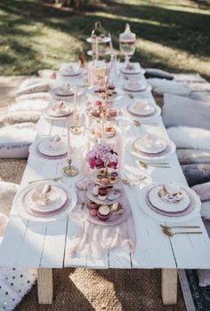 a long table with plates and cups on it