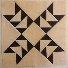 a black and white quilt with triangles on it