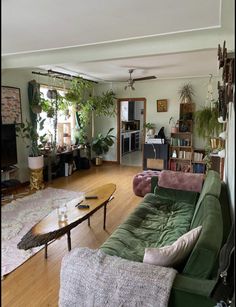 a living room filled with furniture and lots of plants