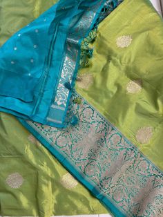 **SILK MARK CERTIFIED** **Gorgeous pure Banarasi Katan Butta Silk Saree with blouse piece (unstitched) in lime green and light blue** **100% silk and high quality** **Direct from Banaras** Material: 100% Katan Silk Blouse piece: Included (Unstitched) Fall and Pico: YES Color: Lime Green, Light Blue Occasion: Festivals, Weddings, Cultural Events, Puja, Parties, Formal Gatherings, Family Functions, Graduations Experience the charm of this Handwoven Green Banarasi Meenakari Katan Silk Saree, a beau Cheap Unstitched Katan Silk Traditional Wear, Green And Blue Saree, Katan Saree, Blue Silk Saree, Katan Silk Saree, Green With Blue, Saree Handloom, San Ramon, Blue Saree