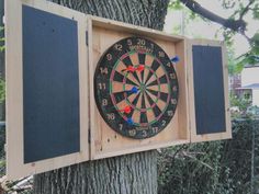 a dart board mounted to the side of a tree