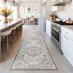 a kitchen with an area rug on the floor