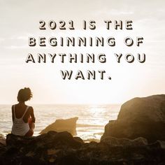 a woman sitting on rocks with the words, 2021 is the beginning of anything you want