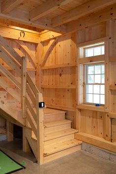 a room with wooden walls and stairs in it