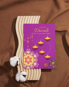 a greeting card with cotton flowers and candles for diwali, the festival of lights