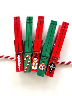 four red and green candy canes with christmas decorations on them