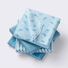 four blue napkins stacked on top of each other