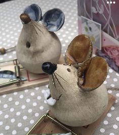 two ceramic mice sitting on top of a table