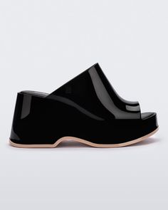 Throwback style meets current trends—that’s just how the Patty rolls. Lightweight and streamlined with a wide strap and a peep toe, these platform mules are true attention seekers, and the contrasting sole detail amps up the cool factor. Made from our revolutionary Melflex® PVC plastic, you enjoy more flexibility and c Chic Platform Slide Slippers, Modern Open Toe Platform Slippers For Spring, Trendy Platform Slip-on Slides, Modern Black Mules With Reinforced Heel, Modern Summer Wedge Heel Slides, Modern Open Toe Platform Slippers, Chic Platform Slides With Round Toe, Modern Summer Slides With Wedge Heel, Modern Black Wedge Heel Mules