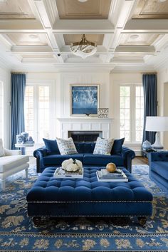 a living room filled with blue couches and furniture