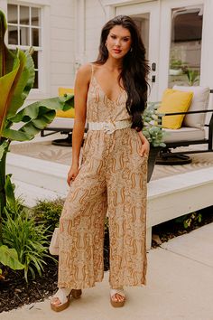 The perfect throw-on-and-go piece, our adorable boho inspired 'Drawn To The Beach Jumpsuit' features soft lightweight material patterned with an intricate mustard colored print, a v-cut neckline and upper back with adjustable spaghetti straps, hidden side pockets, and a slouched silhouette that falls straight into ankle-length hemlines! Measurements S : Bust 38", Hip 40", Inseam 25", Length 56", Waist 38". M : Bust 40", Hip 42", Inseam 25", Length 56.5", Waist 40". L : Bust 42", Hip 44", Inseam Beach Jumpsuit, Beach Jumpsuits, Model Fits, V Cut, V Cuts, Women Clothing Boutique, Hip Length, Online Womens Clothing, Boutique Clothing