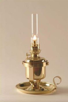 an antique brass oil lamp on a tray