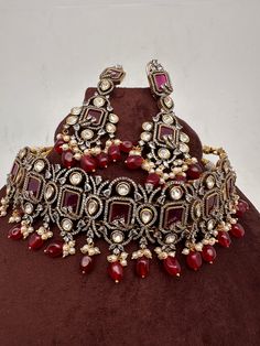 Moissanite Kundan Victorian Mehendi Finish Red Stones and  Red beads Choker with Long Earrings. Sabhysachi Inspired Premium quality Choker. it's a statement choker necklace nice addition to your wardrobe. It's  in Mehendi finish it has copper tone to it. Choker comes with adjust thread(dore) Its a flexible choker fits perfectly on neck. Earrings Length : 3.25 Inches Weight : 20 grams each If you any questions please let me know. Thank you!! Ready to ship from Boston, Massachusetts. Red Kundan Necklace With Intricate Design For Ceremonial Occasions, Ceremonial Red Kundan Necklace With Intricate Design, Red Tikka With Intricate Design For Festive Occasions, Ceremonial Red Kundan Necklace, Red Chandbali Tikka With Intricate Design, Red Hand-set Chandbali Jewelry, Red Chandbali Jewelry With Intricate Design, Red Chandbali Necklace With Intricate Design, Red Kundan Tikka With Intricate Design