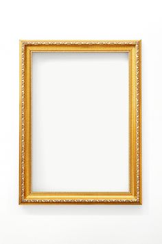 an empty gold frame hanging on the wall