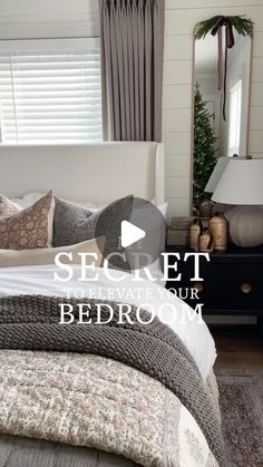 a bed room with a neatly made bed next to a dresser and window covered in curtains