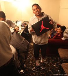 a man holding up a box with the air jordan logo on it