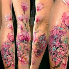 some very pretty tattoos on the legs of someone's legs with flowers painted on them