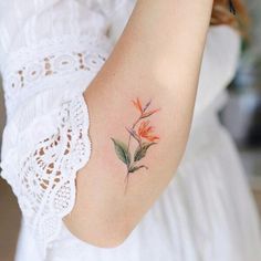 a woman with a flower tattoo on her arm