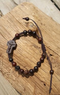 +.God Bless You. +. This is a Wooden Rosary Bracelet. +. It is knotted bracelet and it is adjustable . +. The crufix is carved in elevorate and three dementional shape. +. Beads are more beautiful because they are carved with jujube trees. +.+.+.+.+. Materials +.+.+.+.+.+. Cross: Mpingo (African black wood) beads : jujube tree carved rose wood +.+.+.+.+. Size +.+.+.+.+. Cross : 12mm(Width) *18mm(Height) Beads: 6mm +. Carved characters(e.g. baptismal name, name,etc) on back side +. please send me Adjustable Wooden Beads Spiritual Rosary, Adjustable Brown Hand-strung Rosary, Adjustable Crucifix Jewelry With Wooden Beads, Adjustable Wooden Bead Crucifix Jewelry, Adjustable Brown Spiritual Rosary, Adjustable Wooden Beads Rosary Bracelet Gift, Adjustable Wooden Bead Rosary Bracelet Gift, Adjustable Brown Wooden Beads Rosary Bracelet, Adjustable Crucifix Spiritual Bracelet